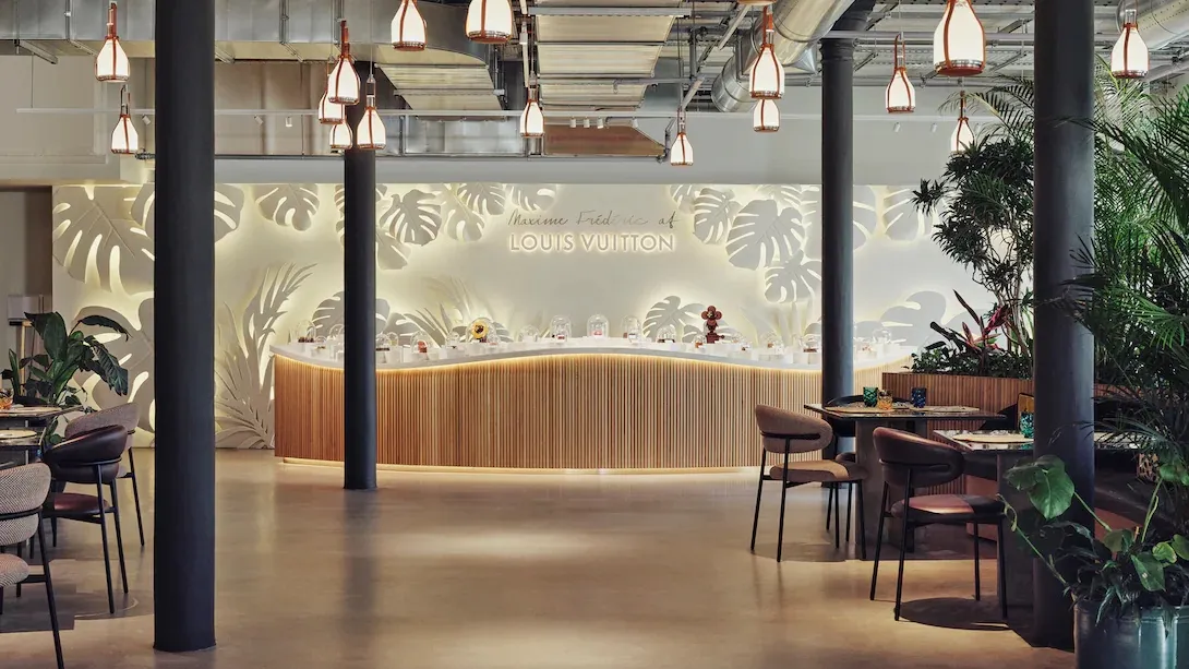 Ambiente do café com vegetação tropical e luminárias suspensas